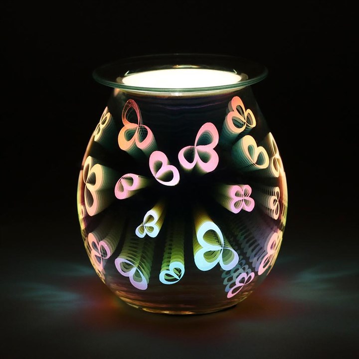 Decorative glass warmer with colorful butterfly designs on a black background