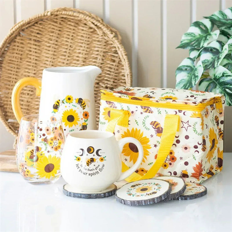 Bee radiant print lunchbag with yellow trim, paired with matching drinkware and coasters.