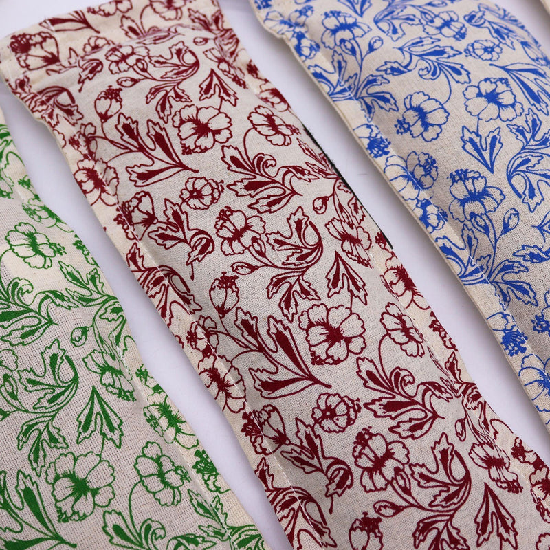 Floral cotton wheat bag fabric close-up in maroon, blue, and green patterns