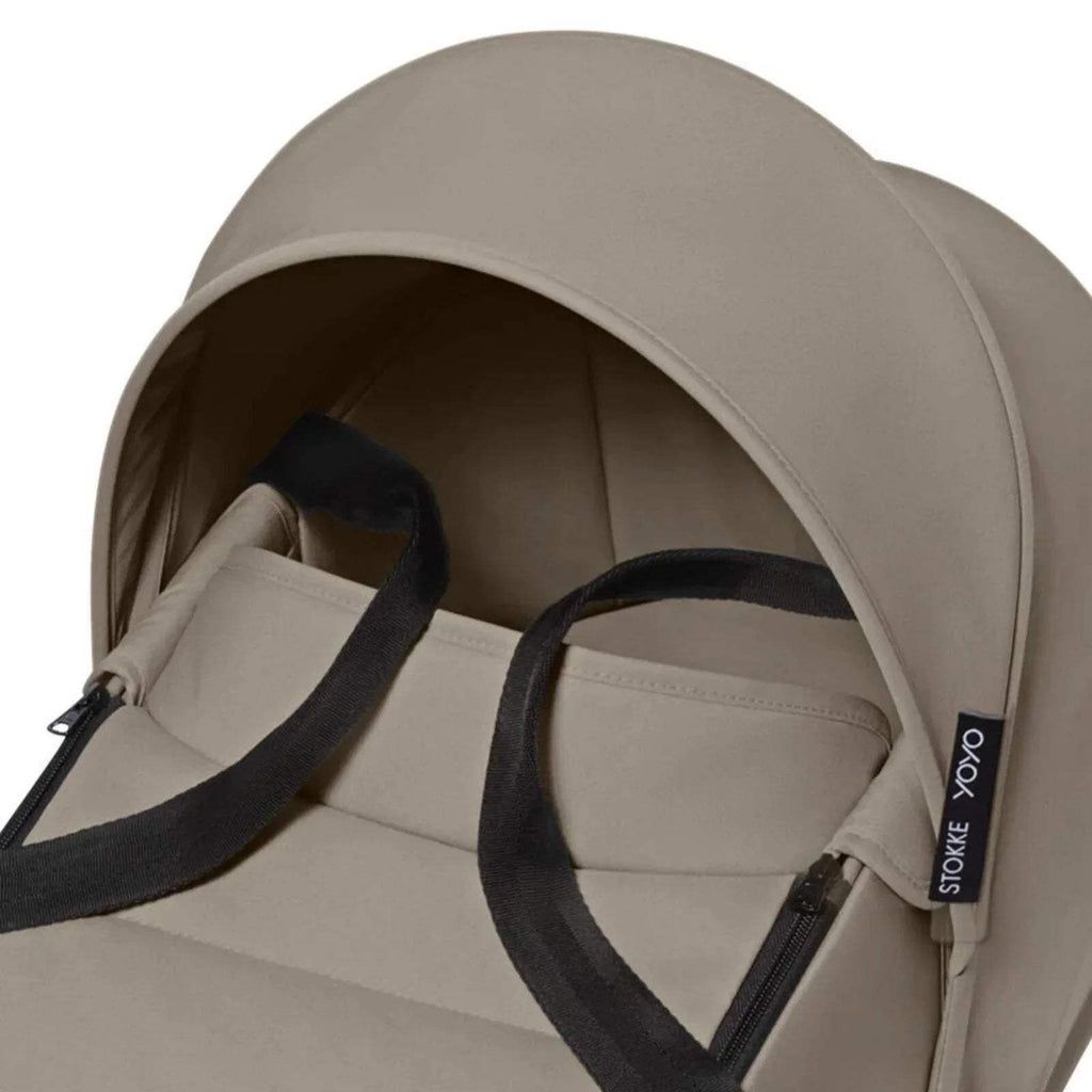 Taupe hooded newborn shell interior with padded lining and black trim