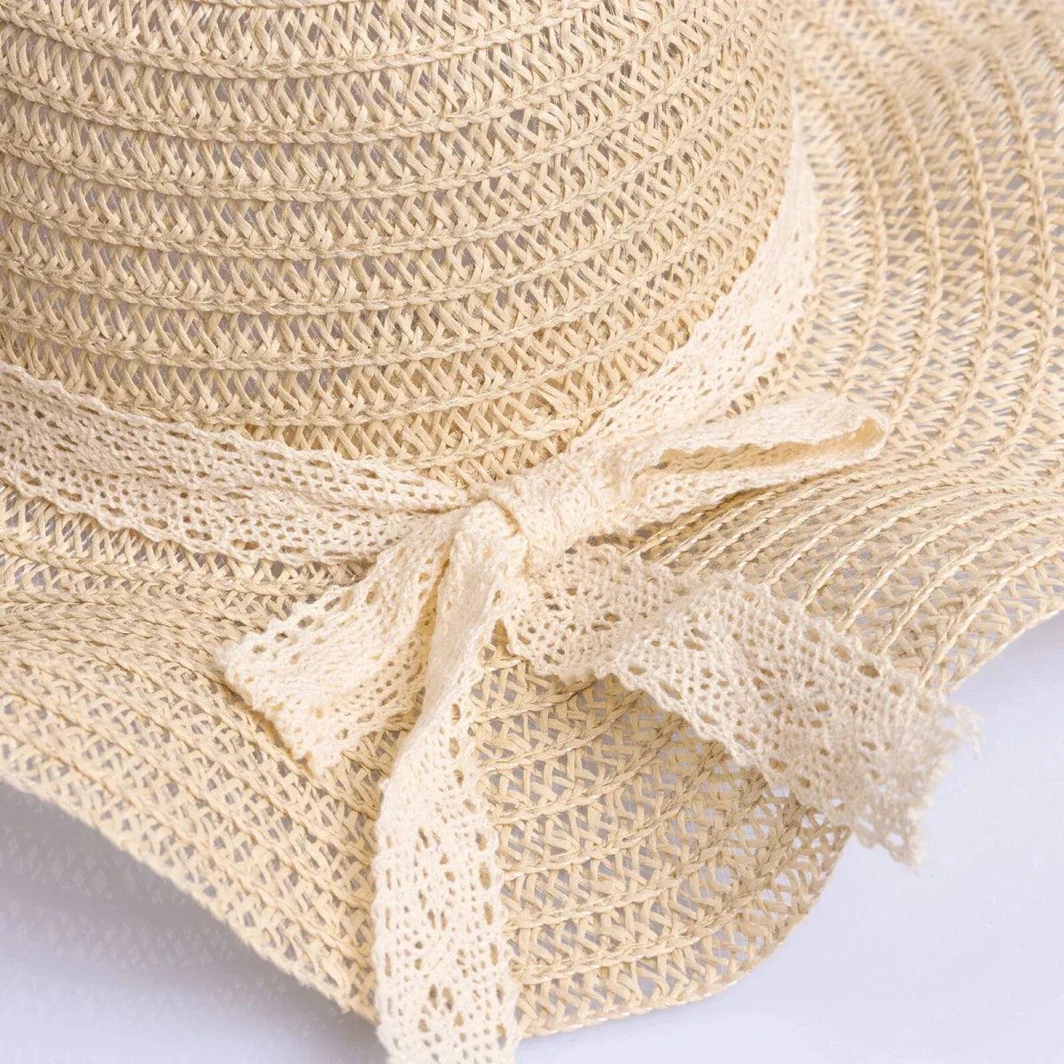 Close-up of ecru straw hat ribbon bow trim and textured weave