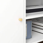 White cabinet door with round gold knob on a TV stand storage compartment.