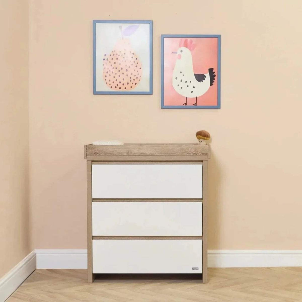 White and light-oak 3-drawer dresser with raised top rail for baby changing.