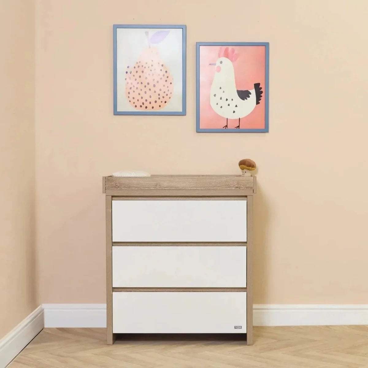 White and light-oak 3-drawer dresser with raised top rail for baby changing.