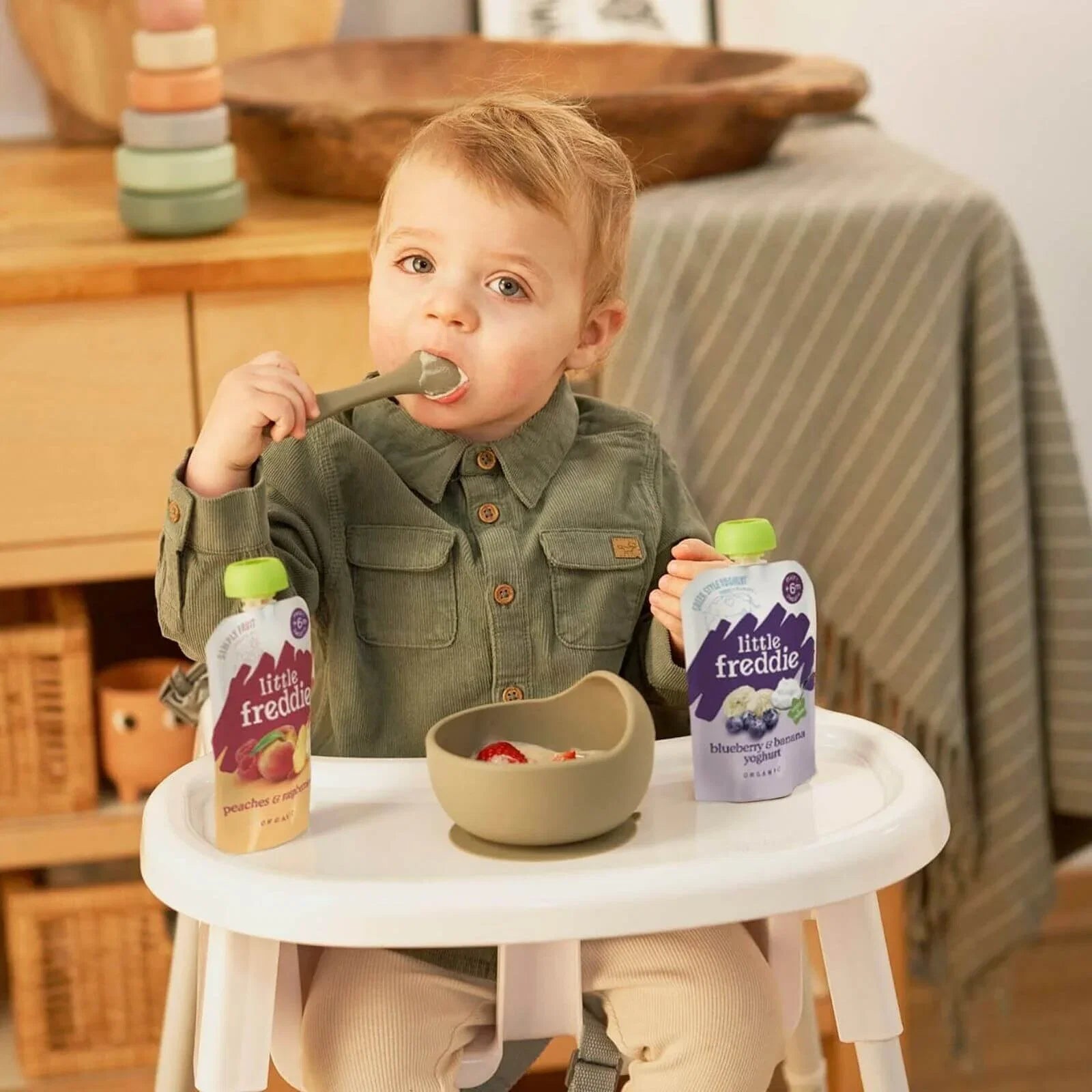 Little Freddie blueberry & banana yogurt pouches on high-chair tray