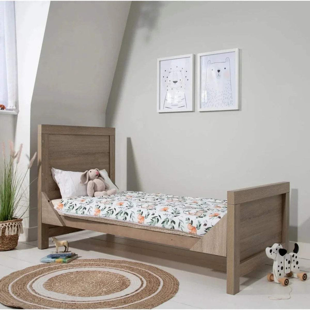 Junior bed in white and light oak with floral mattress cover and pillows