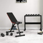 Hex rubber dumbbells on the floor with weight bench in a home gym setup