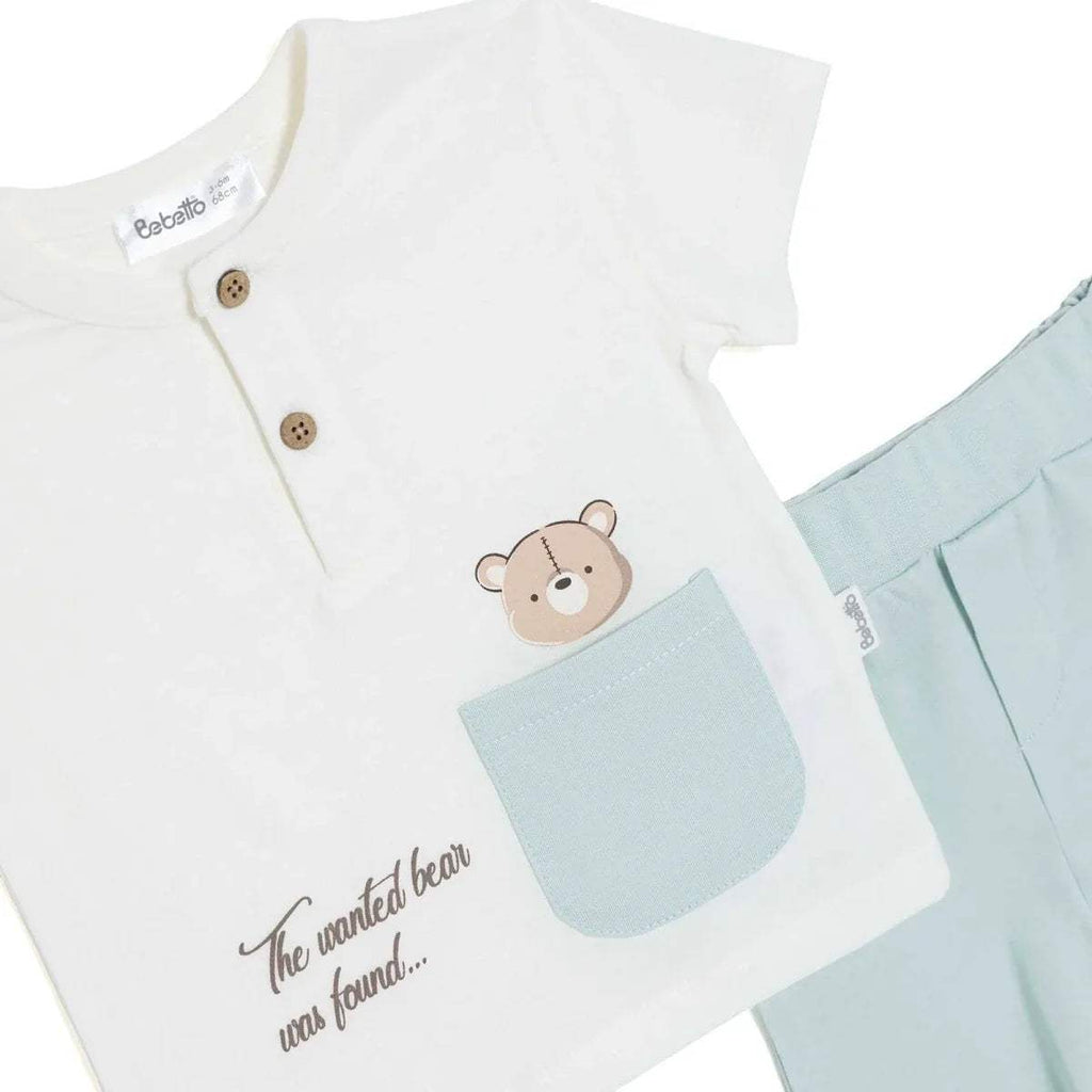 Boys white T-shirt detail with bear graphic, light-blue pocket, and button front