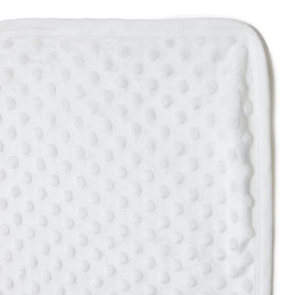 Ecru textured fleece baby blanket surface close-up with stitched border edge