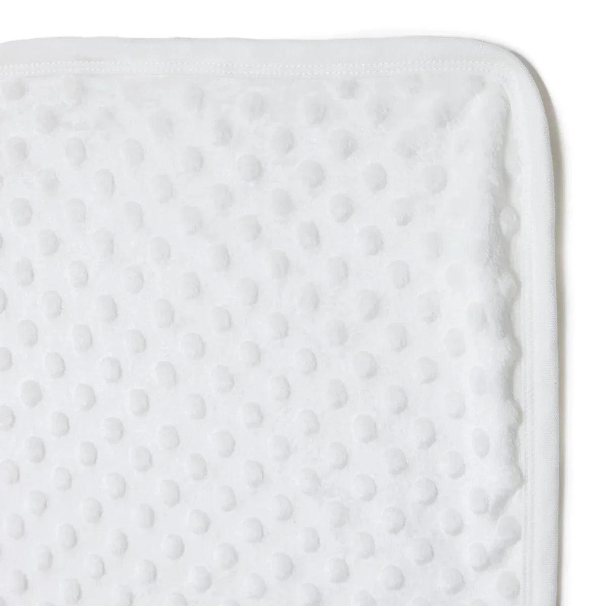 Ecru textured fleece baby blanket surface close-up with stitched border edge