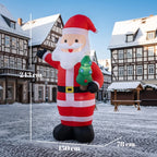 Inflatable red-and-white Santa with raised arm holding a glowing green mini tree