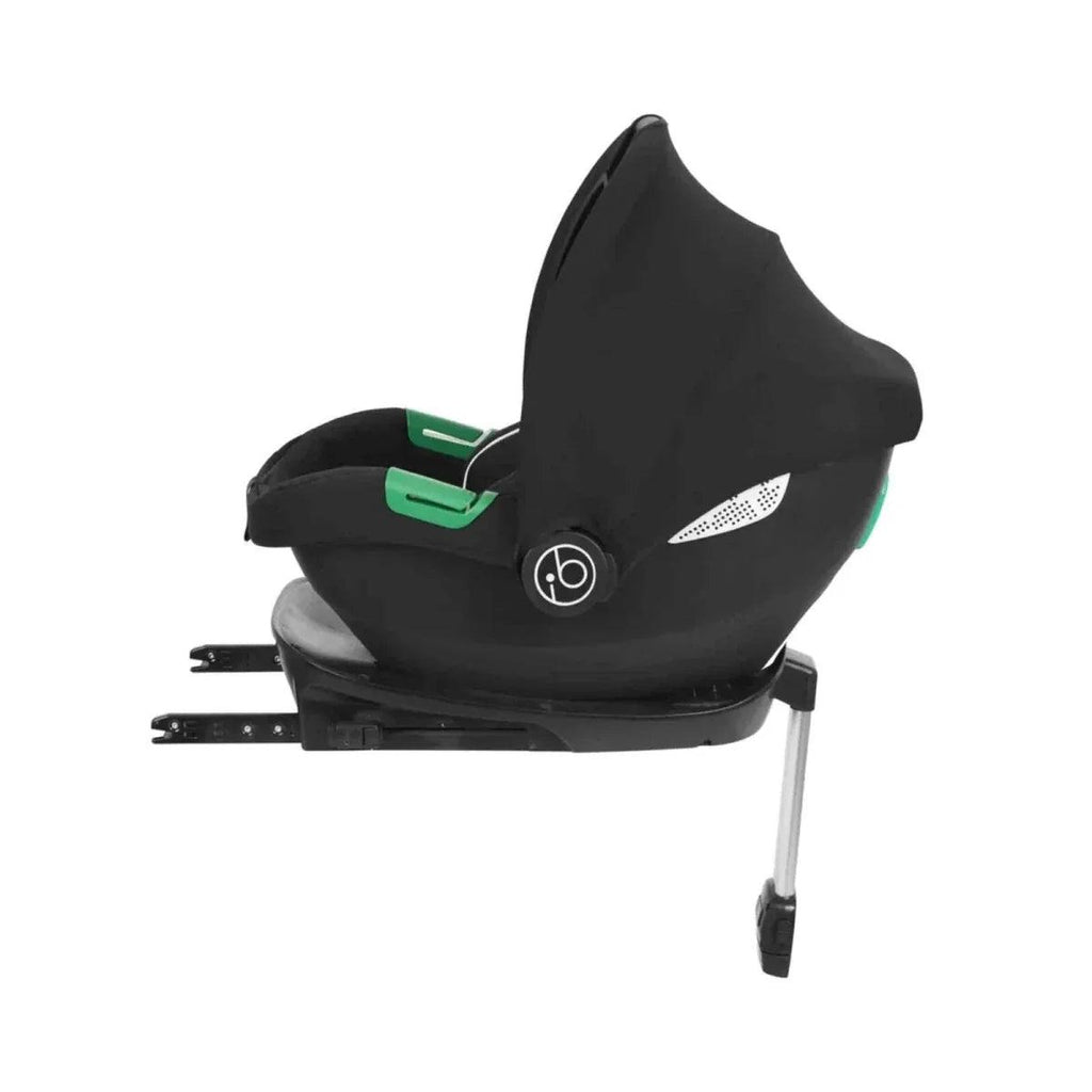 Black infant car seat base with green release panel and side canopy