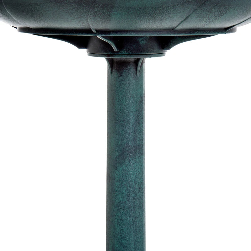Green cast-metal bird bath pedestal with smooth shaft and base connection