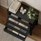 Black dresser with drawers open, showing storage compartments and round knobs