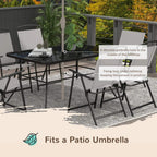 Outdoor dining table with umbrella hole and grey folding chairs on patio