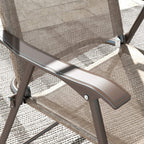 Folding chair armrest and frame detail with protective anti-slip foot pad, mixed brown