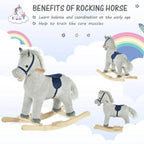 Grey plush rocking horse on wooden rockers with navy saddle, small standing figure view