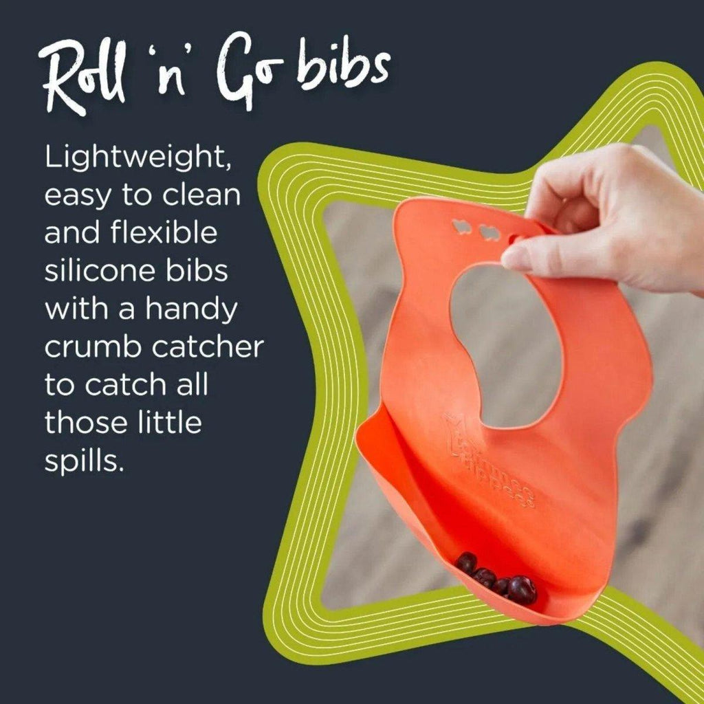 Orange silicone toddler bib with crumb-catching lip, held in hand