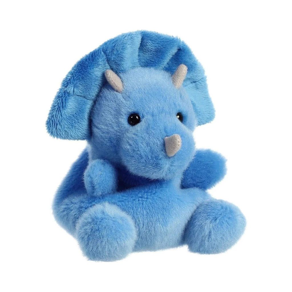 Blue plush triceratops soft toy with cream facial scales, seated, three-quarter view