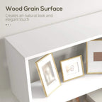 White bookshelf shelf corner with wood-grain surface and framed decor on tier