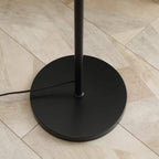 Black round weighted base for a 3-light industrial floor lamp stand