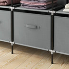 Dark grey fabric drawer fronts on a portable wardrobe frame with corner legs