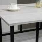 Grey tabletop with textured finish and black metal leg support, close-up