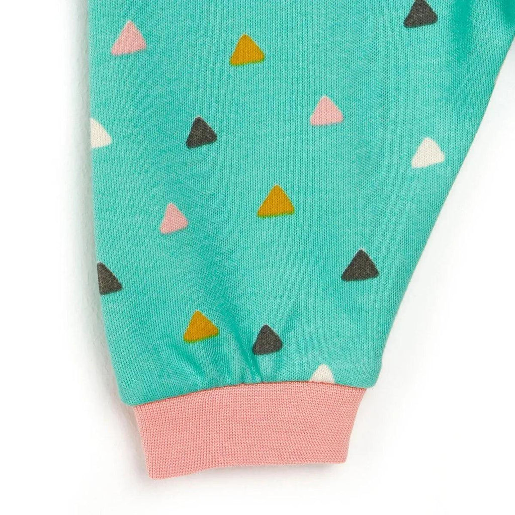 Mint pajama pant cuffs with pink ribbed hem and scattered triangle pattern.