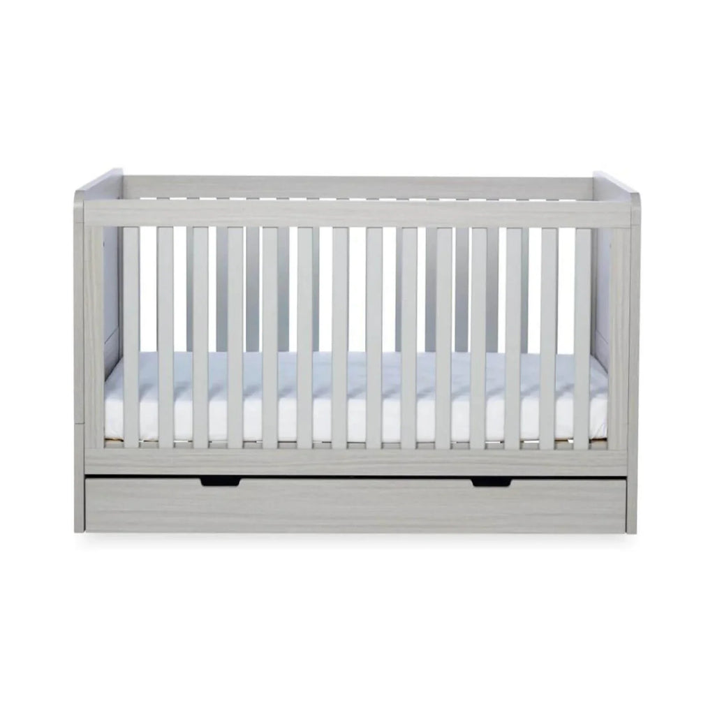 Ash grey cot bed interior with white mattress, vertical railings, and base drawer