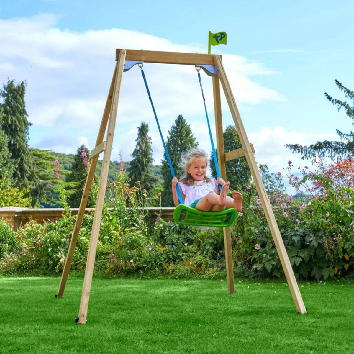 Wooden single swing with green seat; child sitting on swing suspended by blue ropes.