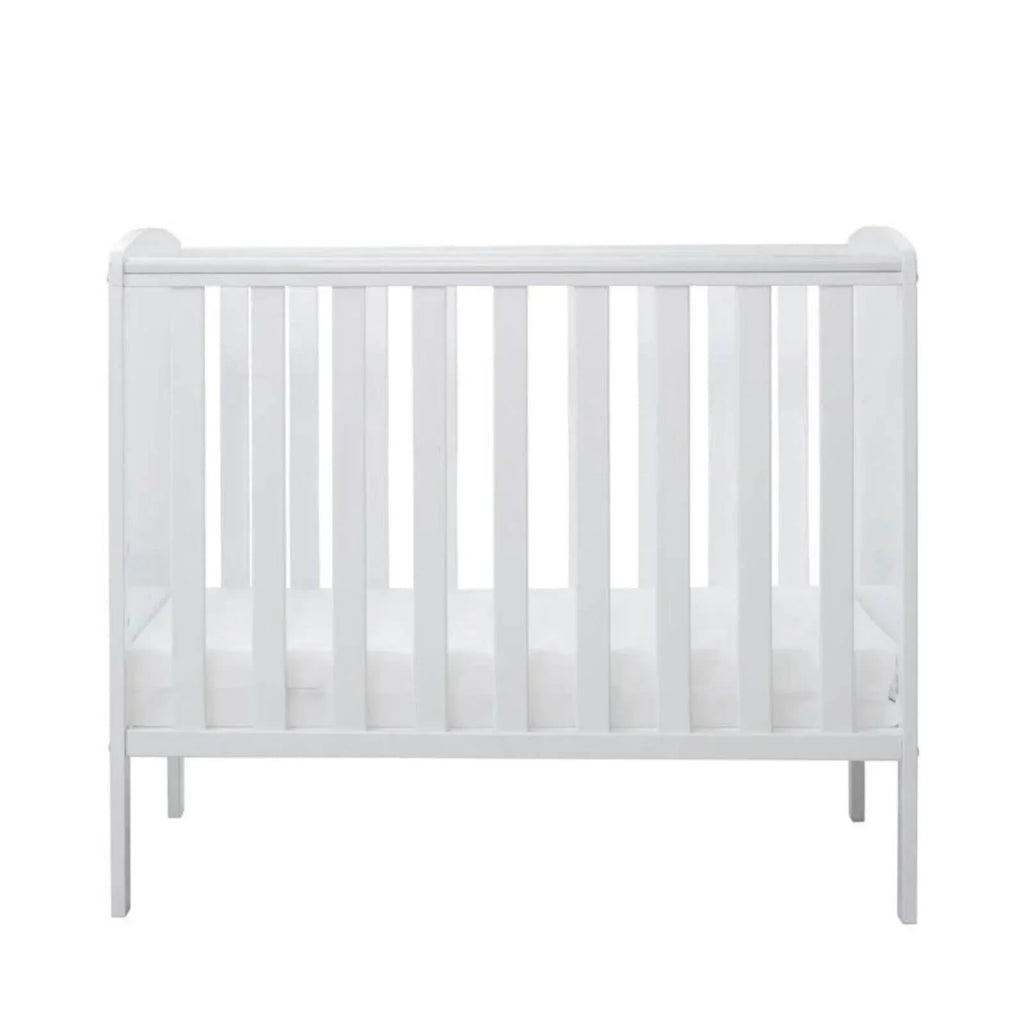 White cot frame with vertical slat rails and four short legs, front view