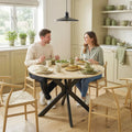 Round natural wood dining table with black X-shaped steel base