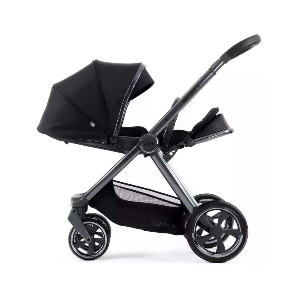 Carbonite single stroller side view with dark canopy, harness, and large wheels
