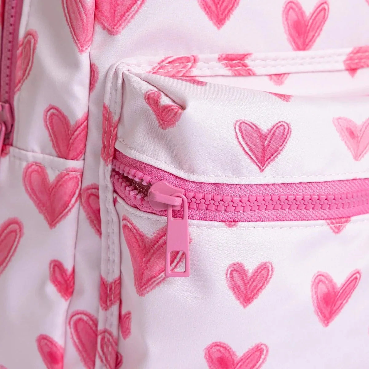 Pink heart-print backpack with pink zipper trim and stitched pocket edge