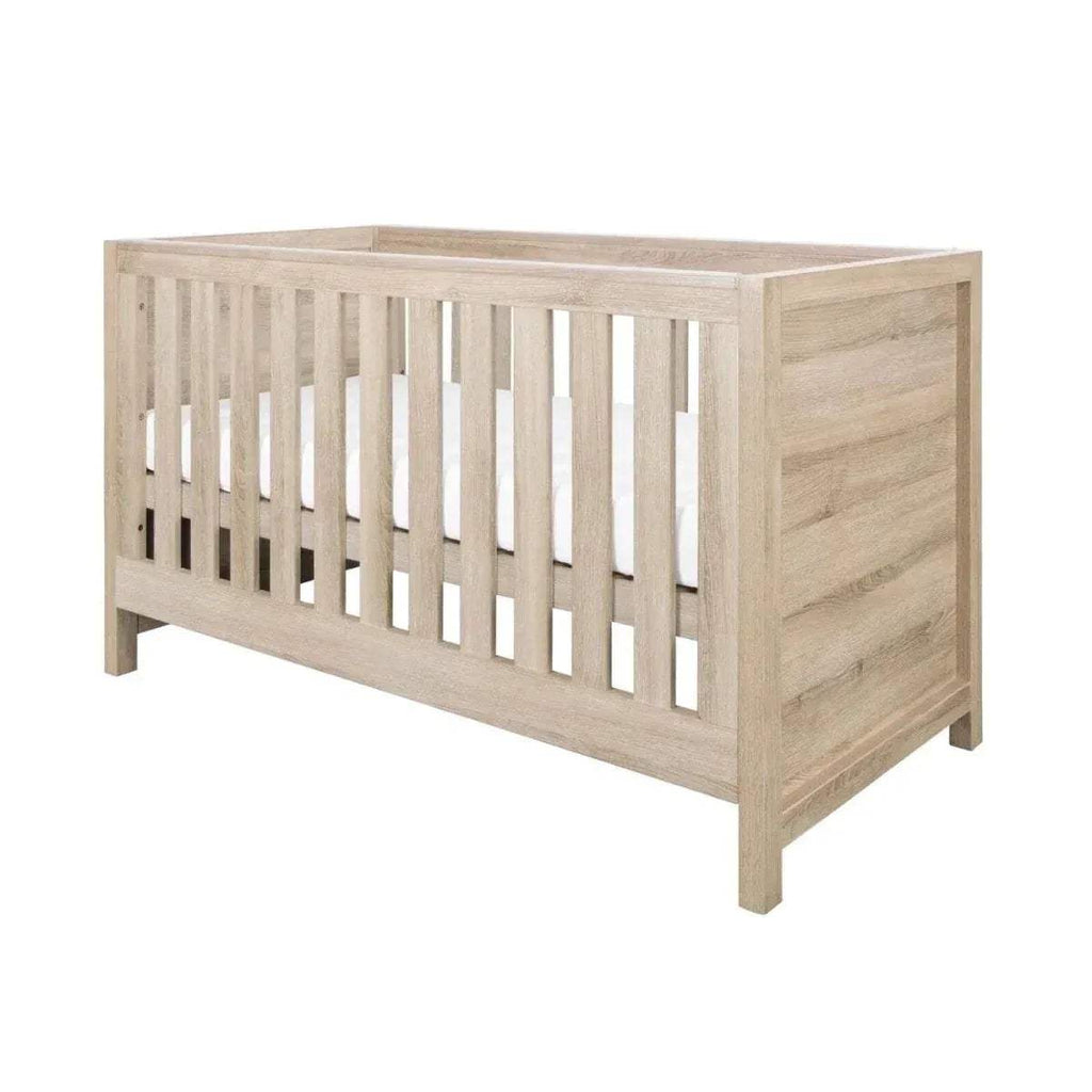 Oak cot bed frame with vertical slats, wide end panels, and sturdy four-leg base