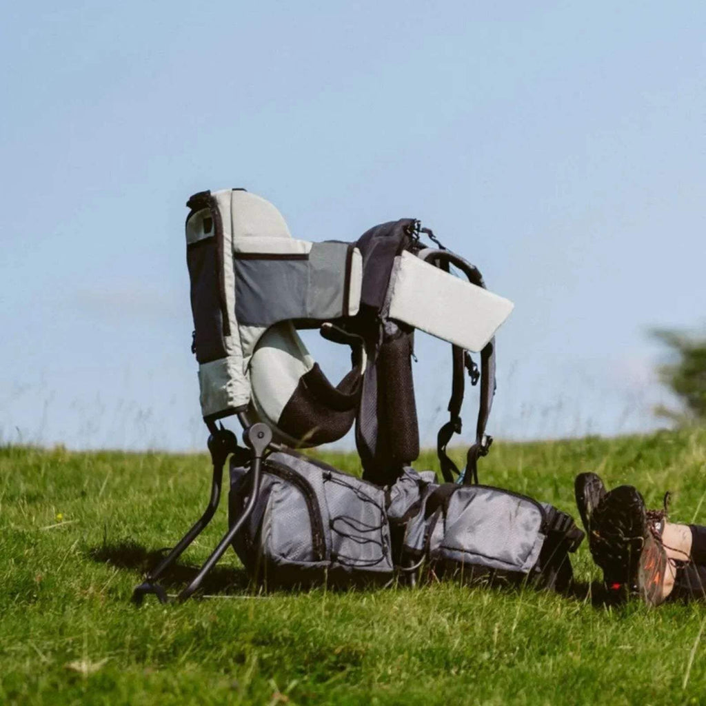 Sage green baby carrier with canopy, front storage pouch, and reclining back panel
