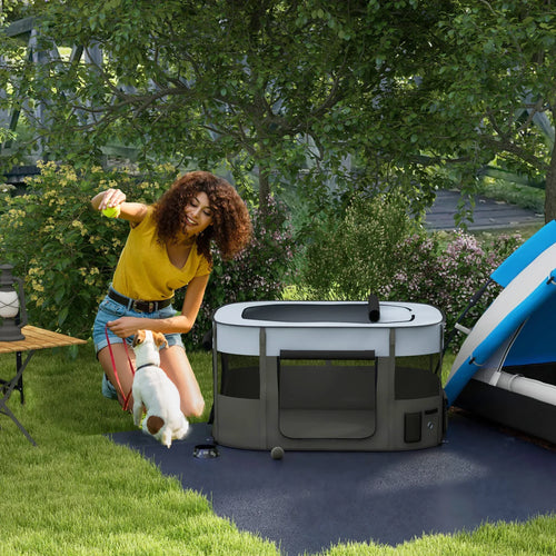 Grey portable dog playpen with mesh sides and zippered entry on outdoor patio