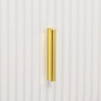 Gold bar handle on a white ribbed drawer front