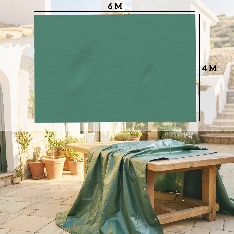 Green waterproof tarpaulin draped over outdoor furniture, with grommet corners