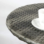 Close-up of woven rattan tabletop edge with dark grey finish