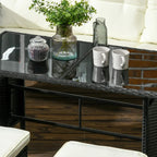 Black rattan glass tabletop with small decor items on a patio furniture set