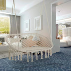 Cream macrame hammock chair with oval woven net seat, hanging ropes, and fringe