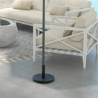 Black umbrella parasol base with upright pole stand on patio floor