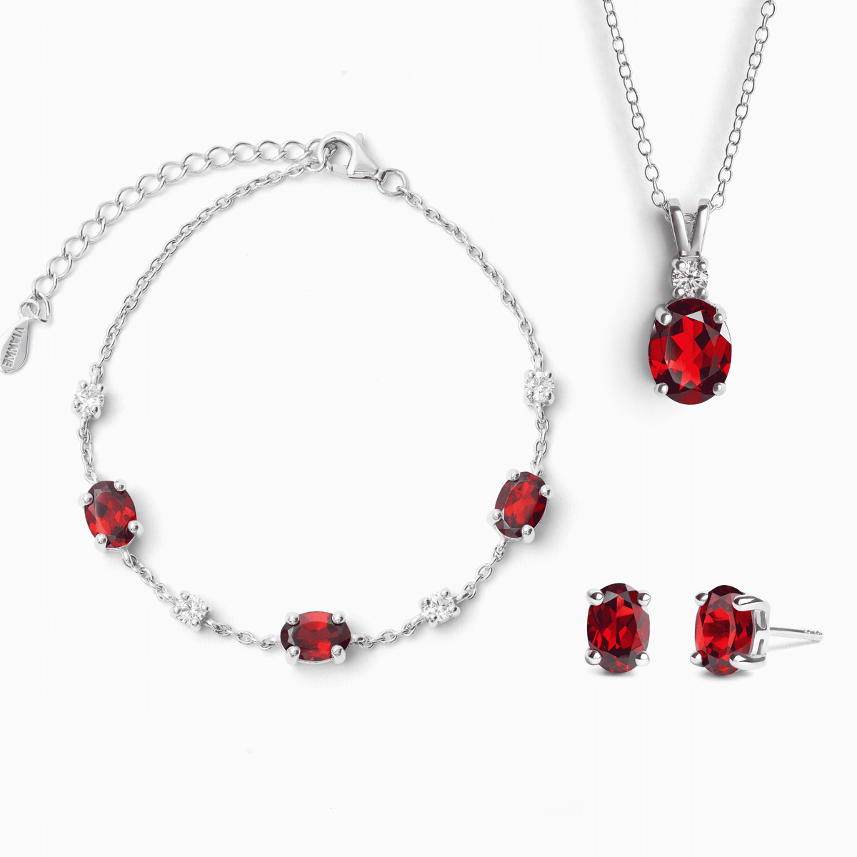 Sterling silver garnet jewelry set with red gemstone necklace, bracelet, and stud earrings