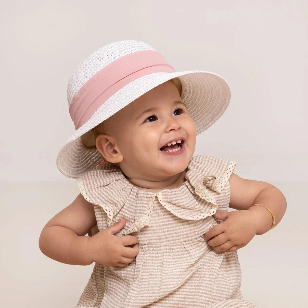 White straw baby sun hat with pink ribbon band on baby