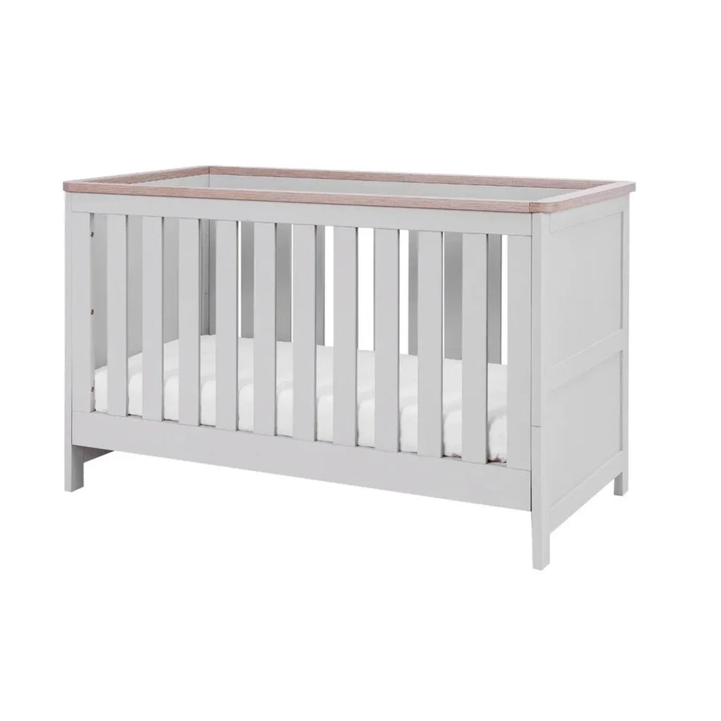 White and dove grey cot bed with vertical slats and oak-toned top rail, side view