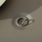 Gas fire pit table control port with round cap and valve-style fitting on tabletop