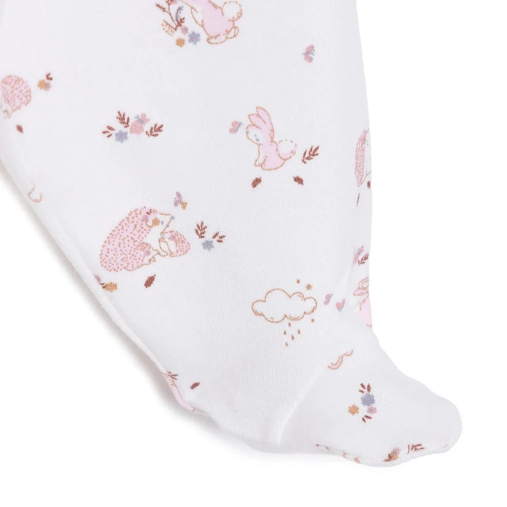 Ecru pajama pants with pink animal and floral prints, shown at the foot