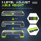 Grey and green aerobic step showing 3-level adjustable height settings and inserts.