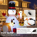 Inflatable snowman and two reindeer with LED glow, red hat, striped scarf, and gift